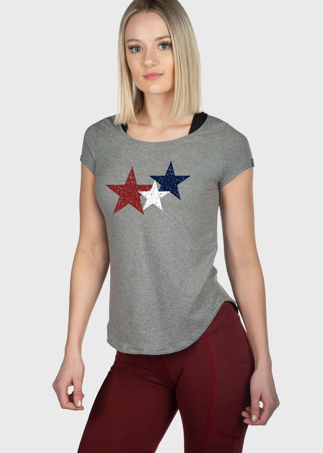 Experience unmatched comfort with the Stars SoftTECH™ Tee. Crafted from super soft SoftTech™ fabric, this tee offers a contour fit that flatters every shape. Its cap sleeves and scoop neck provide a stylish, breathable look while feeling lightweight and comfortable all day long. Designed to feel drier than cotton, it’s perfect for staying fresh. Proudly made in the USA since 1990, this tee combines quality and comfort effortlessly.