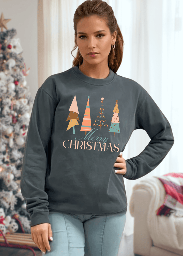 Celebrate the season in comfort with this heavyweight pigment-dyed cotton sweatshirt, featuring a charming pastel Christmas tree graphic. Crafted with excellent USA quality that lasts, this piece offers a relaxed, loose-fitting silhouette perfect for cozy gatherings and casual days. The crew neck and long sleeves provide warmth, while the durable construction ensures it becomes a holiday favorite year after year. Choose from Washed Black, Evergreen, or Mocha