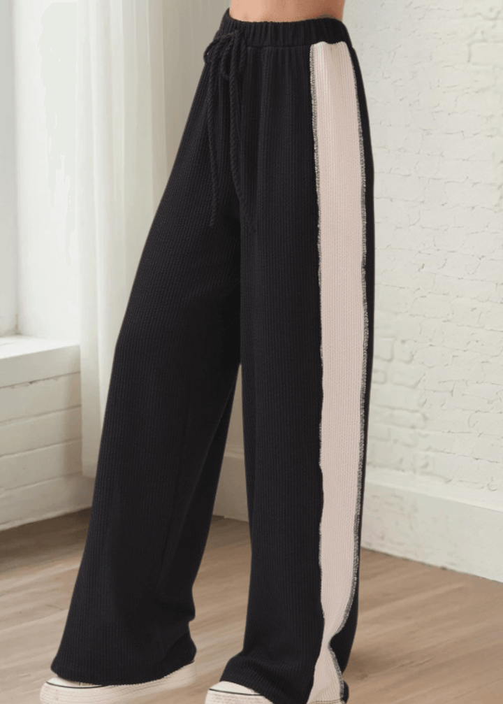 Comfort meets cool in these rib knit wide leg pants (PA1145) featuring bold contrast side panels. Designed and made in USA with a relaxed fit, elastic waistband, and drawstring