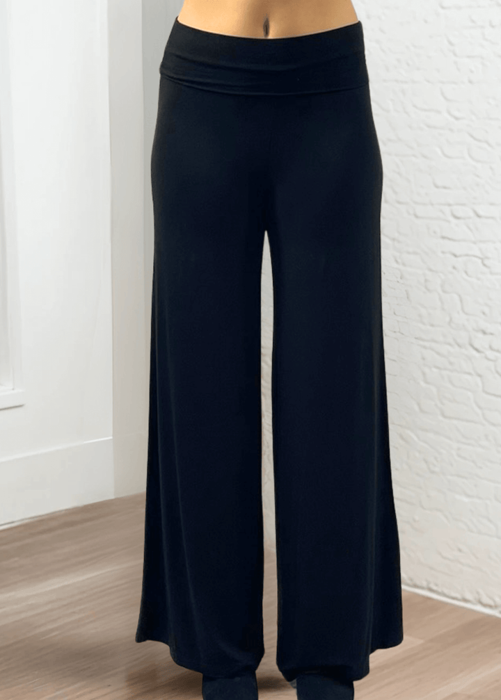 Experience ultimate comfort and style with these Soft Rayon Jersey Palazzo Pants in Solid Black, crafted in the USA. Featuring a flattering fold-over waist and a wide-leg silhouette, they offer a relaxed yet chic look. Made from a stretchy blend of rayon and spandex, these pants move with you while maintaining their softness.