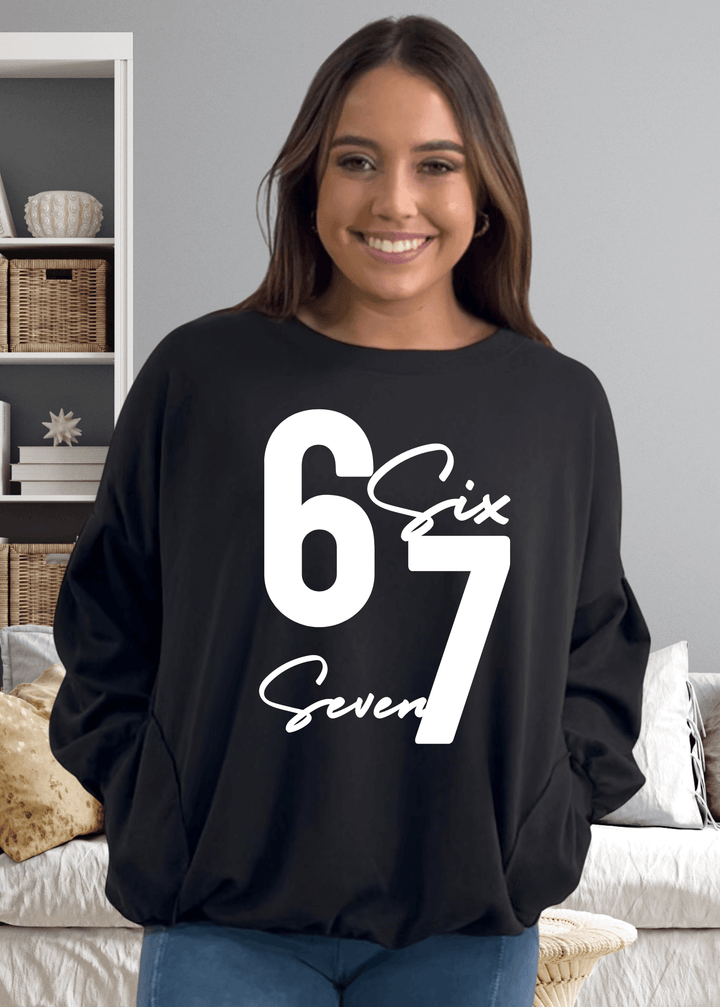 Elevate your cozy game with the "Six Seven" sweatshirt—a playful oversized essential that's anything but basic, in black with white graphic.  This medium-weight French terry piece features a bold graphic on black, paired with a chic keyhole cutout at the back for unexpected flair. Made in USA