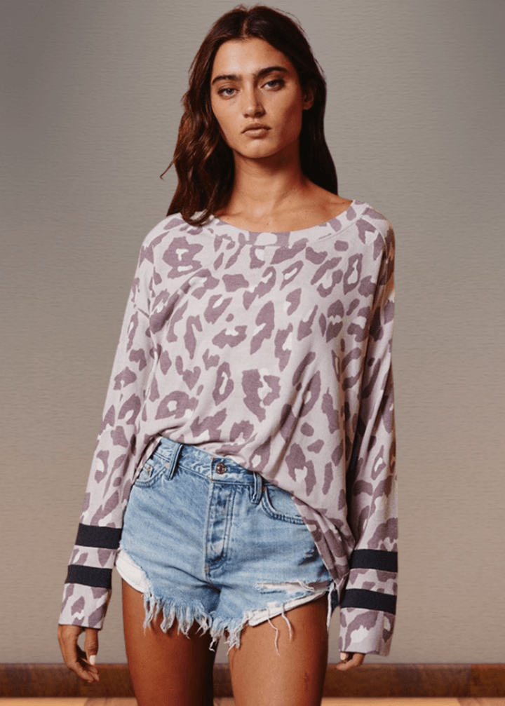 Experience effortless style with the Dusty Lavender Animal Print Top. Its wide round neckline and relaxed fit provide comfort without compromising on fashion.  Bucket List Style T1100