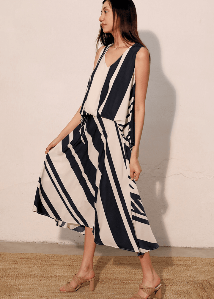 Effortlessly versatile, the Sienna Stripe Midi Swing Skirt delivers timeless appeal with its classic black and ivory vertical stripes. The flowing midi silhouette flatters all body types while the lightweight fabric and elastic waistband ensure comfort from morning through evening Paired with Effortless sophistication meets everyday comfort in this sleeveless striped top. The classic black and ivory stripe pattern pairs with a flattering V-neckline, while strategic front gathering creates the polished look 