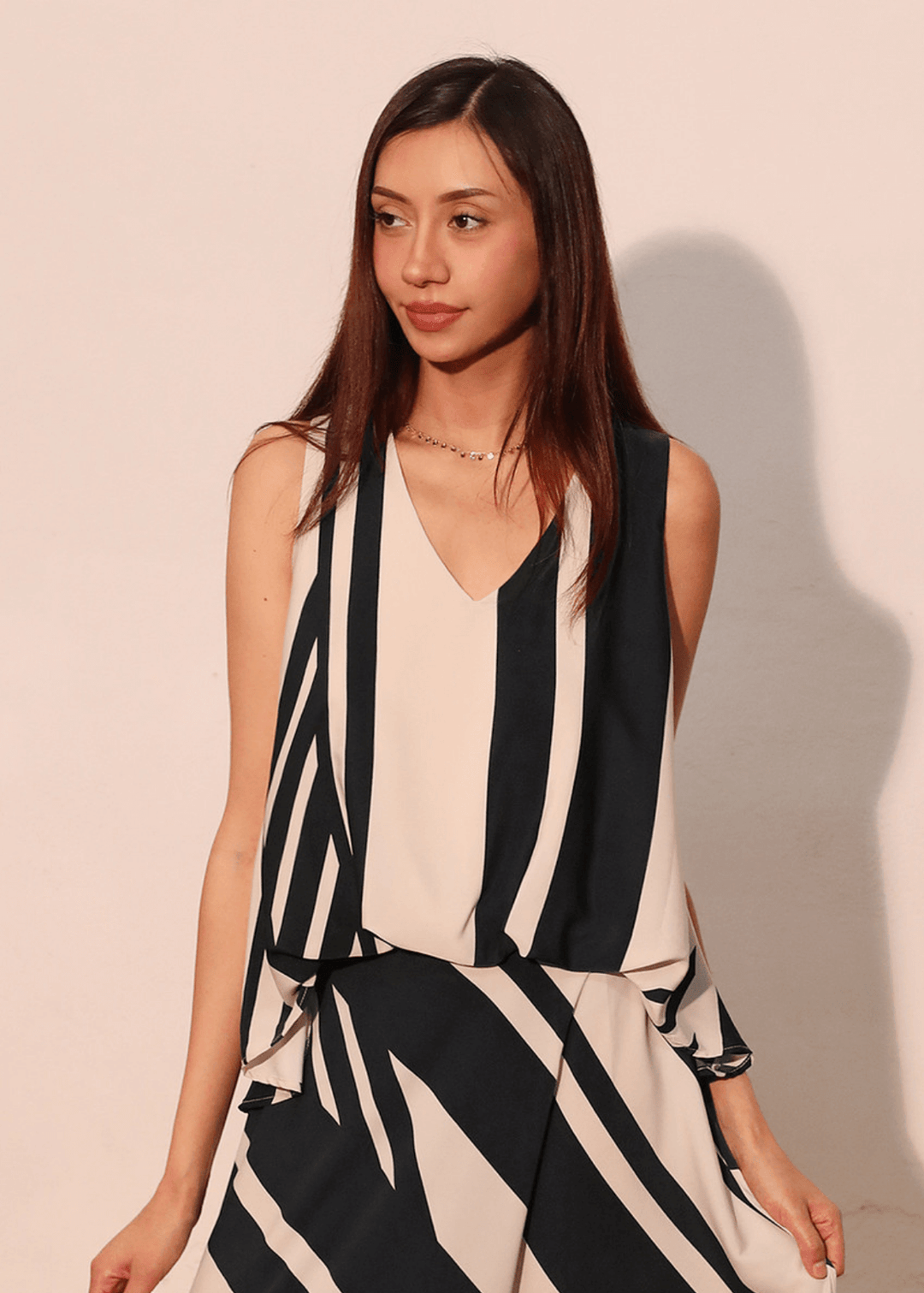 Effortless sophistication meets everyday comfort in this sleeveless striped top. The classic black and ivory stripe pattern pairs with a flattering V-neckline, while strategic front gathering creates the polished look of a tucked-in style. Made in USA
