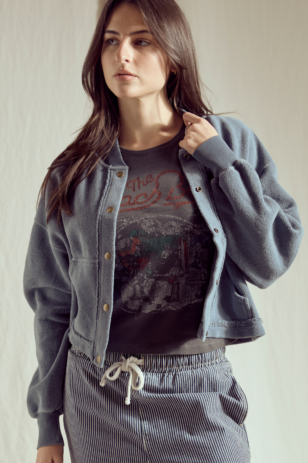 Shop the Sundown Jacket by People of Leisure — an oversized 100% organic fleece jacket with pockets, bold buttons & drawstring waist. In Vintage Black & Navy. Sizes XS–XL.