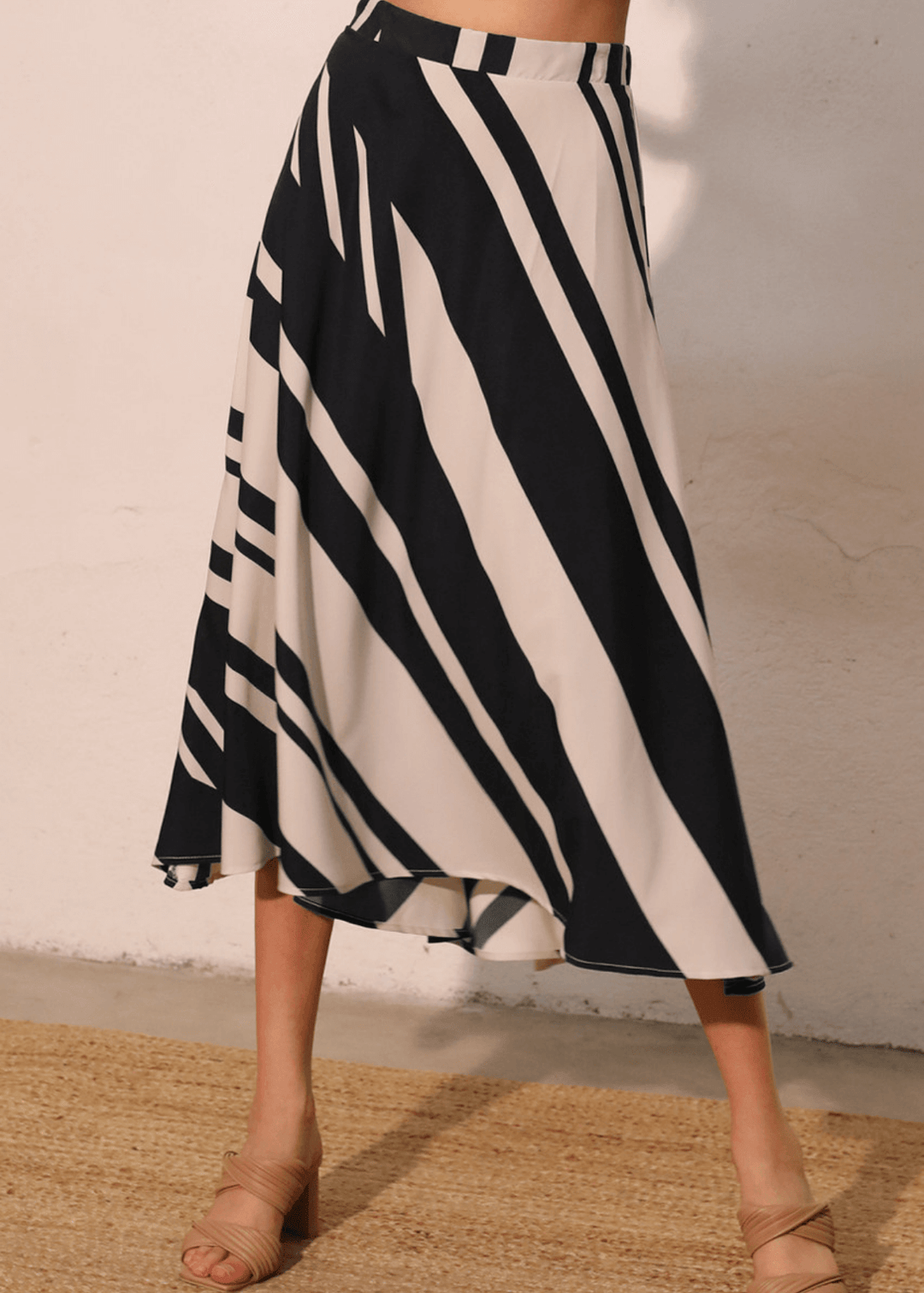 Effortlessly versatile, the Sienna Stripe Midi Swing Skirt delivers timeless appeal with its classic black and ivory vertical stripes. The flowing midi silhouette flatters all body types while the lightweight fabric and elastic waistband ensure comfort from morning through evening. 