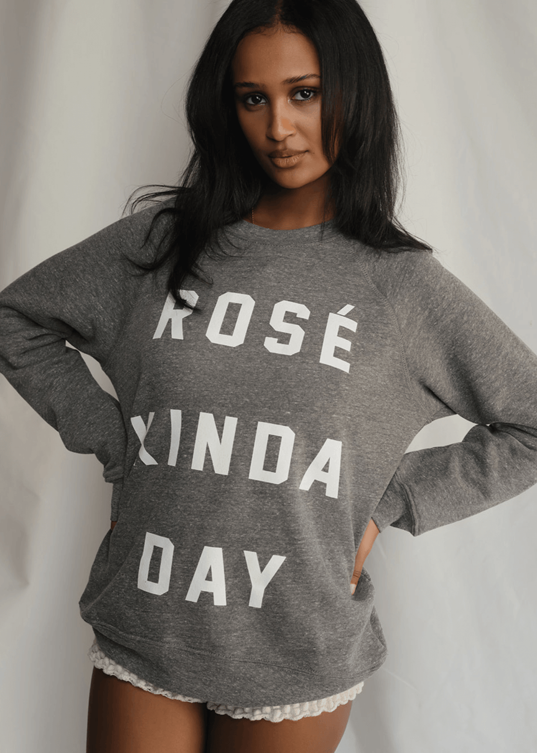 Warning: May induce day-drinking fantasies. This heather grey sweatshirt isn't subtle. Bold white letters scream what you're really thinking: "Rosé Kinda Day." Crafted for comfort with a touch of daring attitude