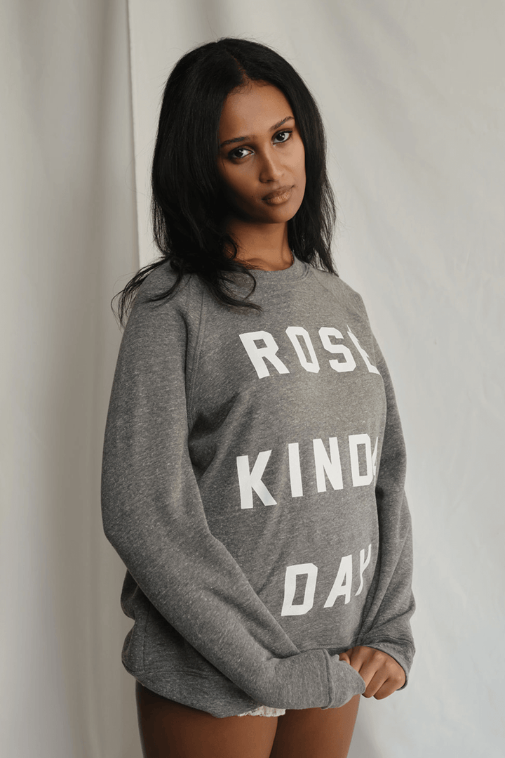 Warning: May induce day-drinking fantasies. This heather grey sweatshirt isn't subtle. Bold white letters scream what you're really thinking: "Rosé Kinda Day." Crafted for comfort with a touch of daring attitude