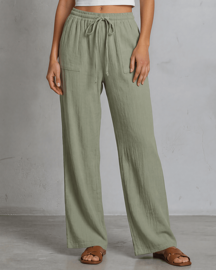 Annie wide leg pants in light olive — adjustable drawstring waist, side pockets, rayon-linen blend. Relaxed fit, Made in USA. Perfect for resort &amp; vacation wear.
