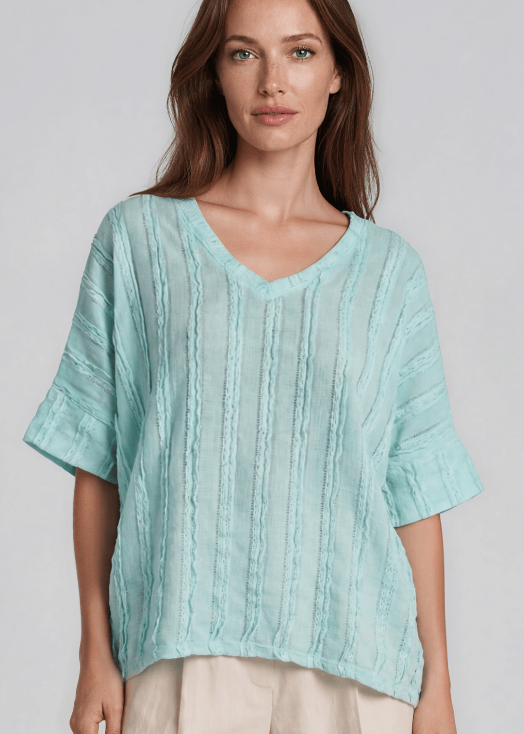 Shop the Laurel Textured Top in Aqua Blue — a relaxed oversized v-neck with striped lace effect, contrast sleeve bands & side slit. Made in USA.