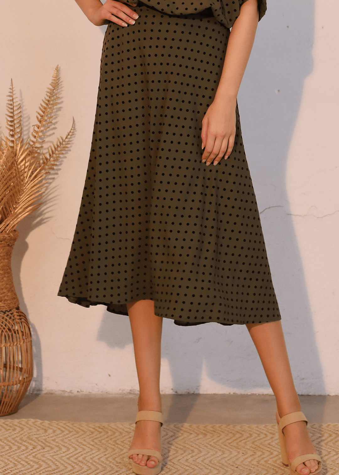 Elevate your wardrobe with this expertly crafted in USA  midi swing skirt, designed to flatter and move with you. The soft flocked polka dot pattern in dark olive green with black dots adds visual interest while maintaining sophistication. 
