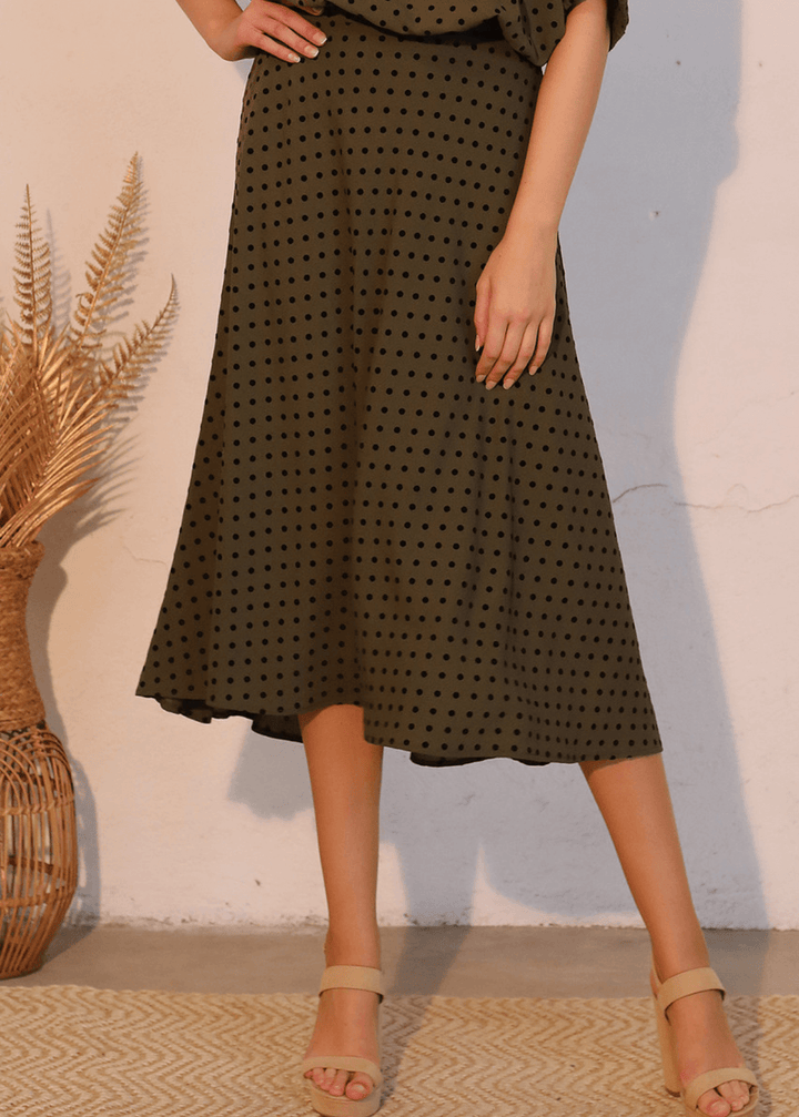 Elevate your wardrobe with this expertly crafted in USA  midi swing skirt, designed to flatter and move with you. The soft flocked polka dot pattern in dark olive green with black dots adds visual interest while maintaining sophistication. 