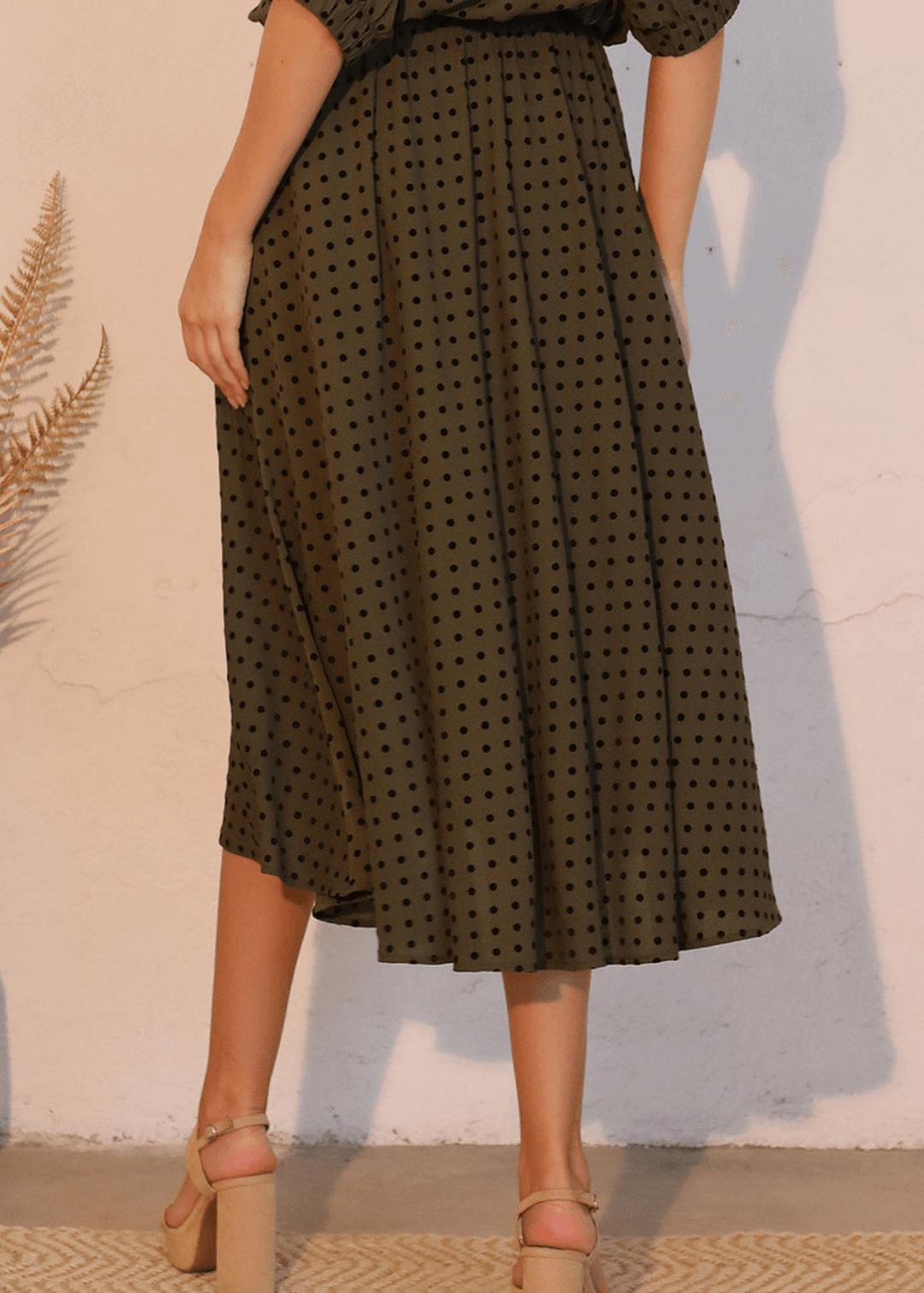 Elevate your wardrobe with this expertly crafted in USA  midi swing skirt, designed to flatter and move with you. The soft flocked polka dot pattern in dark olive green with black dots adds visual interest while maintaining sophistication. 