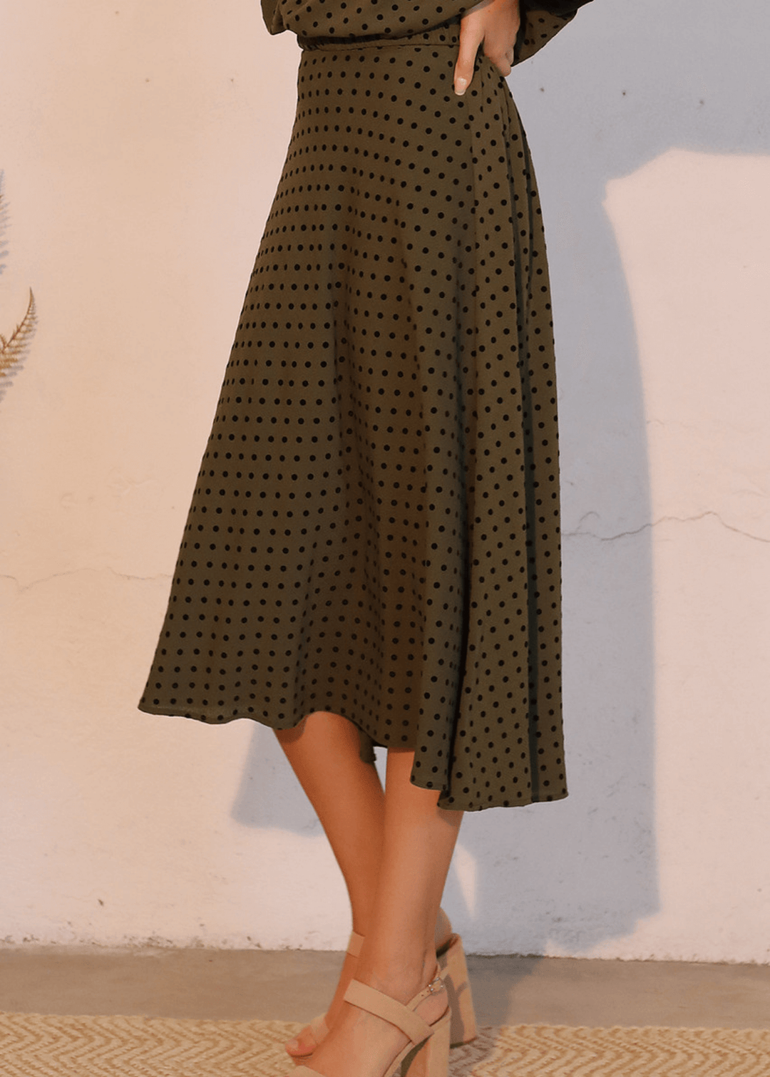 Elevate your wardrobe with this expertly crafted in USA  midi swing skirt, designed to flatter and move with you. The soft flocked polka dot pattern in dark olive green with black dots adds visual interest while maintaining sophistication. 