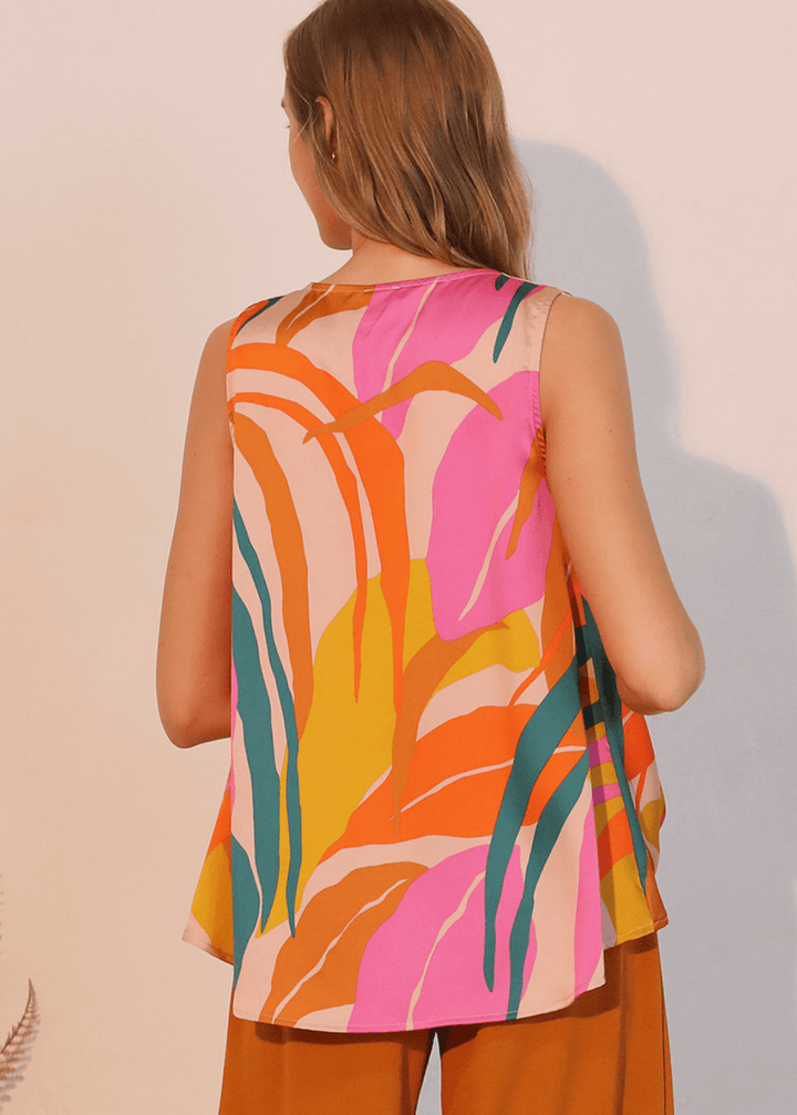 This Women's Tropical Front Tucked Top, made in the USA, combines thoughtful design with practical versatility. The sleeveless V-neck silhouette features front gathering at the hem that creates a structured tuck effect.
