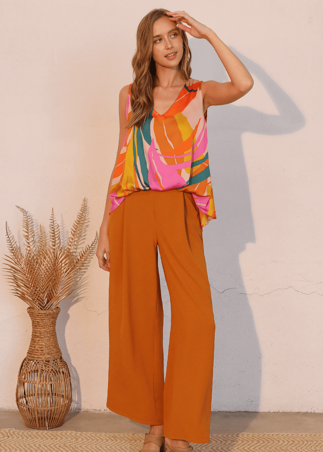 This Women's Tropical Front Tucked Top, made in the USA, combines thoughtful design with practical versatility. The sleeveless V-neck silhouette features front gathering at the hem that creates a structured tuck effect.
