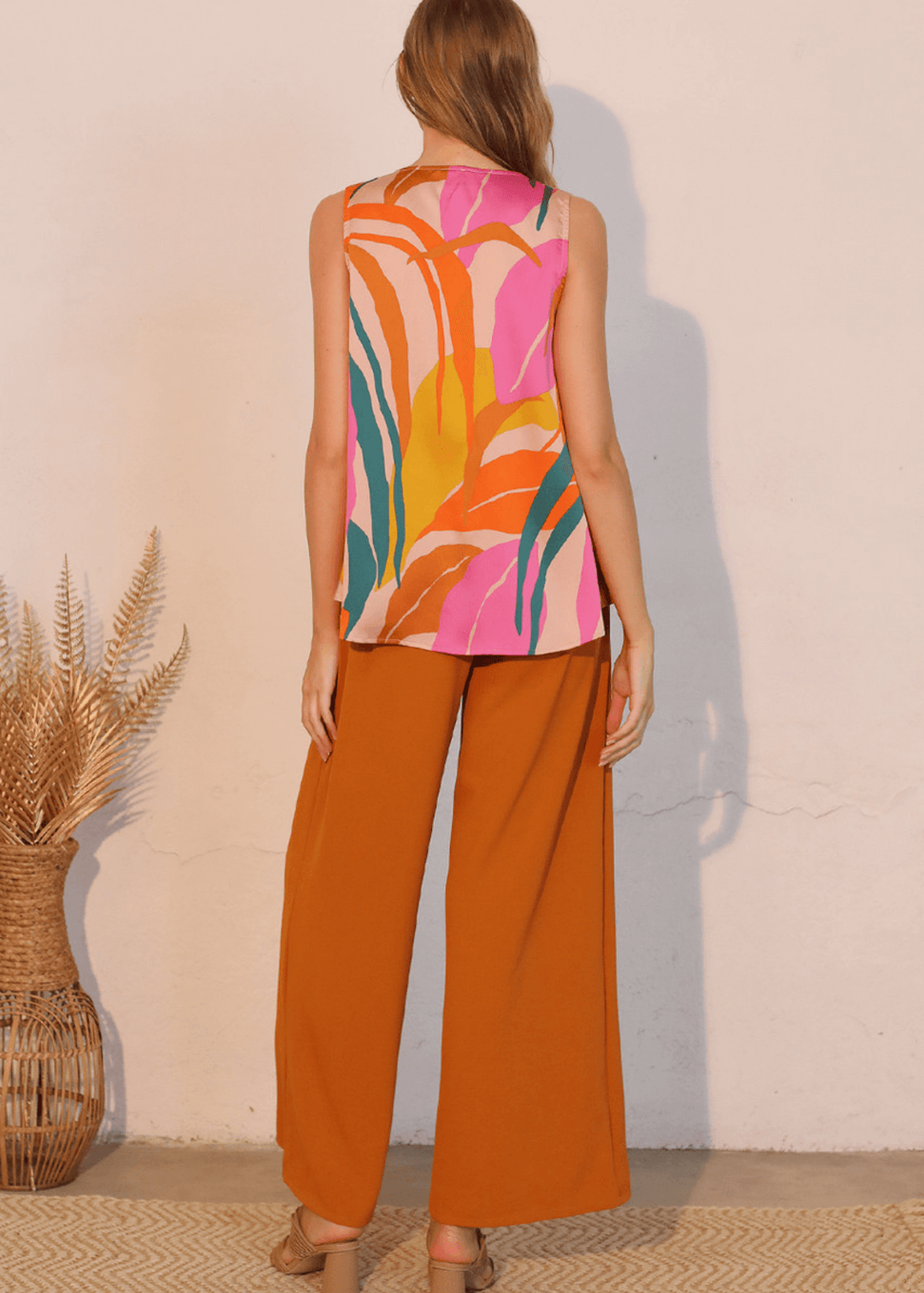 This Women's Tropical Front Tucked Top, made in the USA, combines thoughtful design with practical versatility. The sleeveless V-neck silhouette features front gathering at the hem that creates a structured tuck effect.