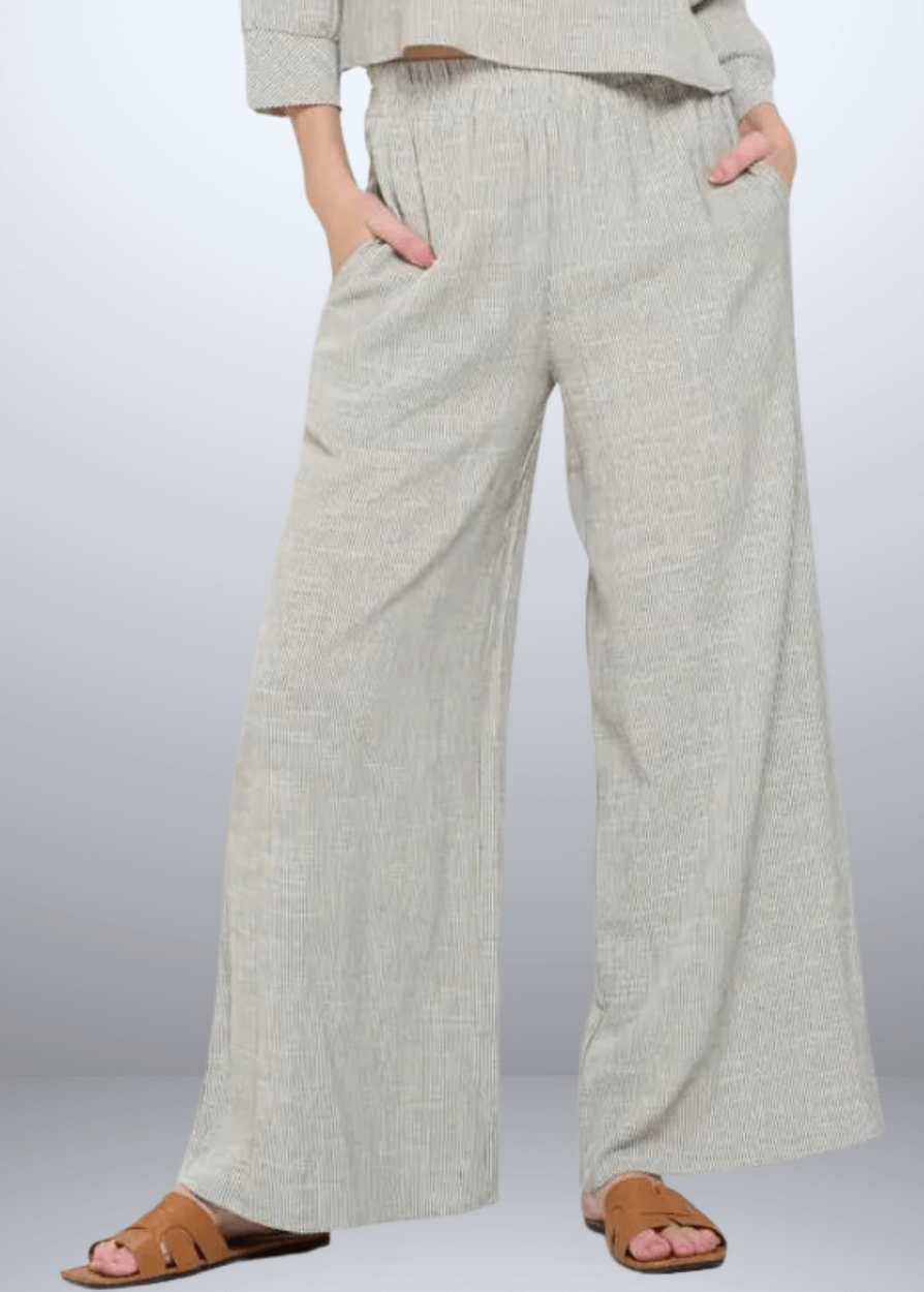 Experience effortless style with the Jane Casual Striped Wide Leg Pants with side pockets, crafted in the USA from a breathable cotton blend. Featuring a relaxed wide-leg fit and classic striped pattern, Convenient side pockets add practicality, while the blend of cotton, rayon, and linen ensures softness and durability. Renee C Style 4552PTB