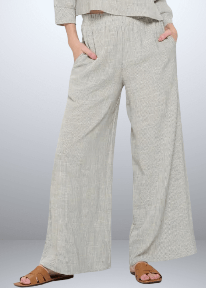 Experience effortless style with the Jane Casual Striped Wide Leg Pants with side pockets, crafted in the USA from a breathable cotton blend. Featuring a relaxed wide-leg fit and classic striped pattern, Convenient side pockets add practicality, while the blend of cotton, rayon, and linen ensures softness and durability. Renee C Style 4552PTB