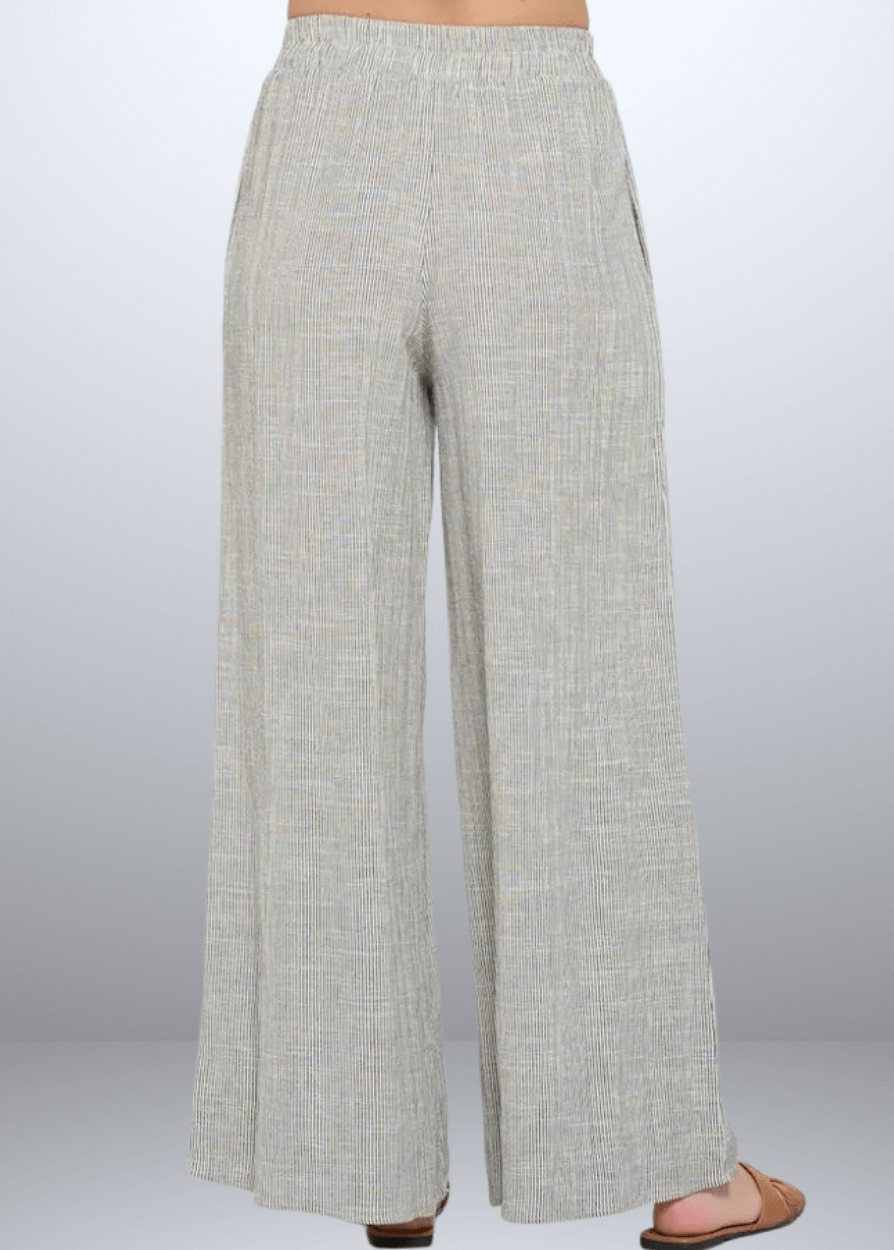 Experience effortless style with the Jane Casual Striped Wide Leg Pants with side pockets, crafted in the USA from a breathable cotton blend. Featuring a relaxed wide-leg fit and classic striped pattern, Convenient side pockets add practicality, while the blend of cotton, rayon, and linen ensures softness and durability. Renee C Style 4552PTB