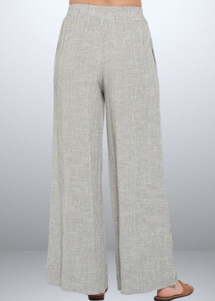 Experience effortless style with the Jane Casual Striped Wide Leg Pants with side pockets, crafted in the USA from a breathable cotton blend. Featuring a relaxed wide-leg fit and classic striped pattern, Convenient side pockets add practicality, while the blend of cotton, rayon, and linen ensures softness and durability. Renee C Style 4552PTB