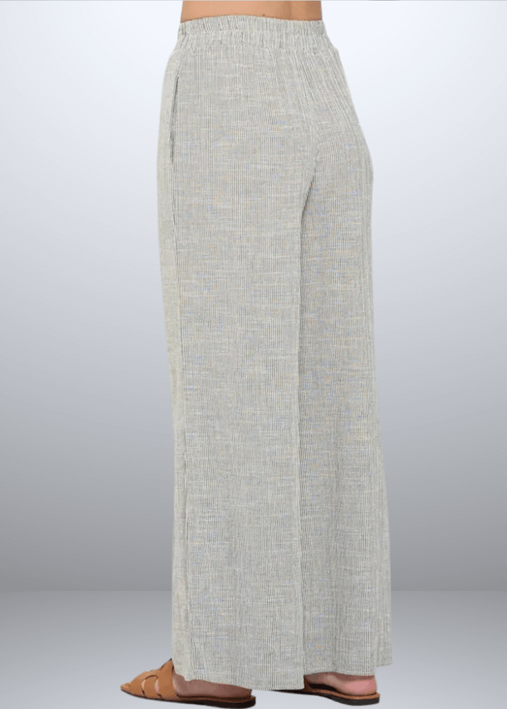 Experience effortless style with the Jane Casual Striped Wide Leg Pants with side pockets, crafted in the USA from a breathable cotton blend. Featuring a relaxed wide-leg fit and classic striped pattern, Convenient side pockets add practicality, while the blend of cotton, rayon, and linen ensures softness and durability. Renee C Style 4552PTB