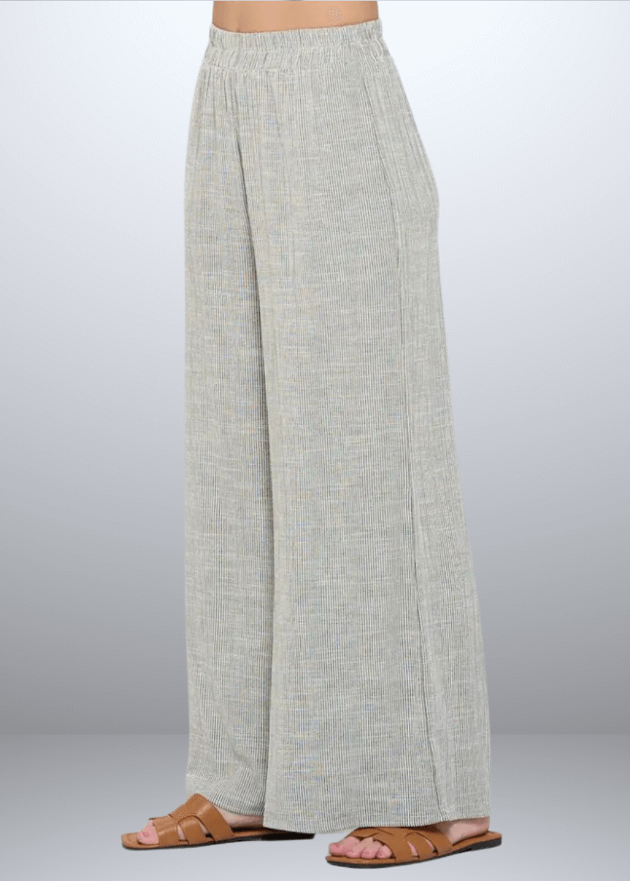 Experience effortless style with the Jane Casual Striped Wide Leg Pants with side pockets, crafted in the USA from a breathable cotton blend. Featuring a relaxed wide-leg fit and classic striped pattern, Convenient side pockets add practicality, while the blend of cotton, rayon, and linen ensures softness and durability. Renee C Style 4552PTB
