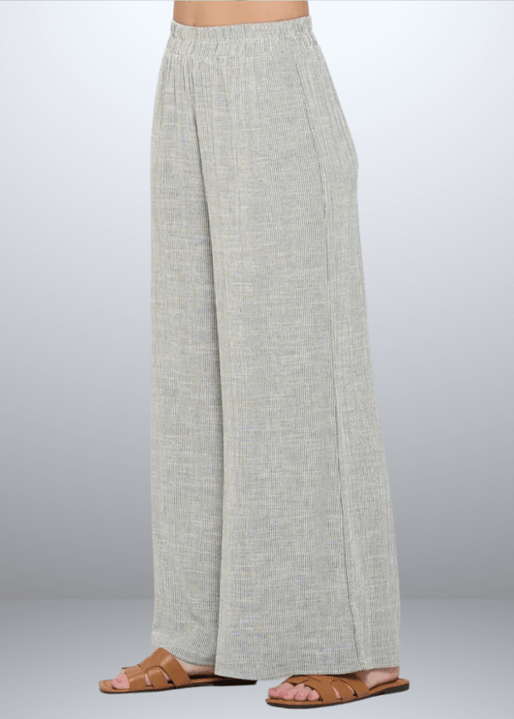 Experience effortless style with the Jane Casual Striped Wide Leg Pants with side pockets, crafted in the USA from a breathable cotton blend. Featuring a relaxed wide-leg fit and classic striped pattern, Convenient side pockets add practicality, while the blend of cotton, rayon, and linen ensures softness and durability. Renee C Style 4552PTB