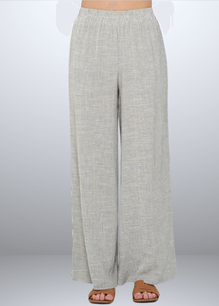 Experience effortless style with the Jane Casual Striped Wide Leg Pants with side pockets, crafted in the USA from a breathable cotton blend. Featuring a relaxed wide-leg fit and classic striped pattern, Convenient side pockets add practicality, while the blend of cotton, rayon, and linen ensures softness and durability. Renee C Style 4552PTB
