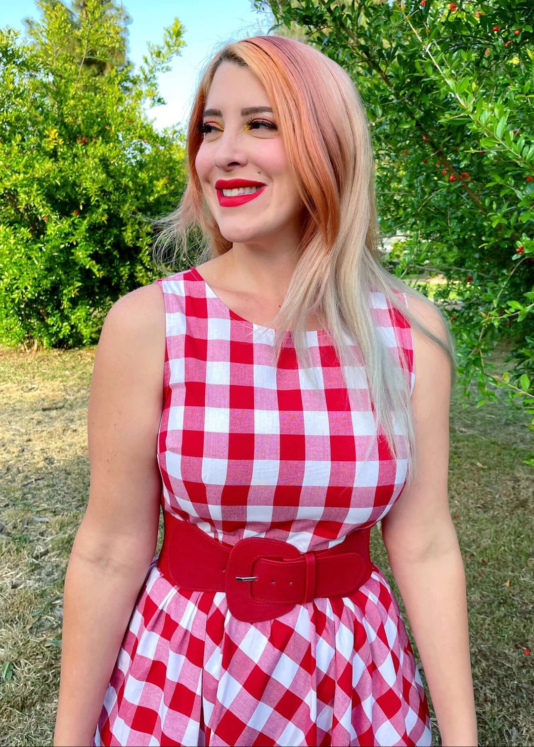 Made in USA Women's vintage style piece with fun, modern details; our midi dress is now available in our adorable red gingham. Made from 100% cotton, this classic 1950's inspired dress features a high neckline, longer length swing skirt with hidden side pockets, and back zippered closure.