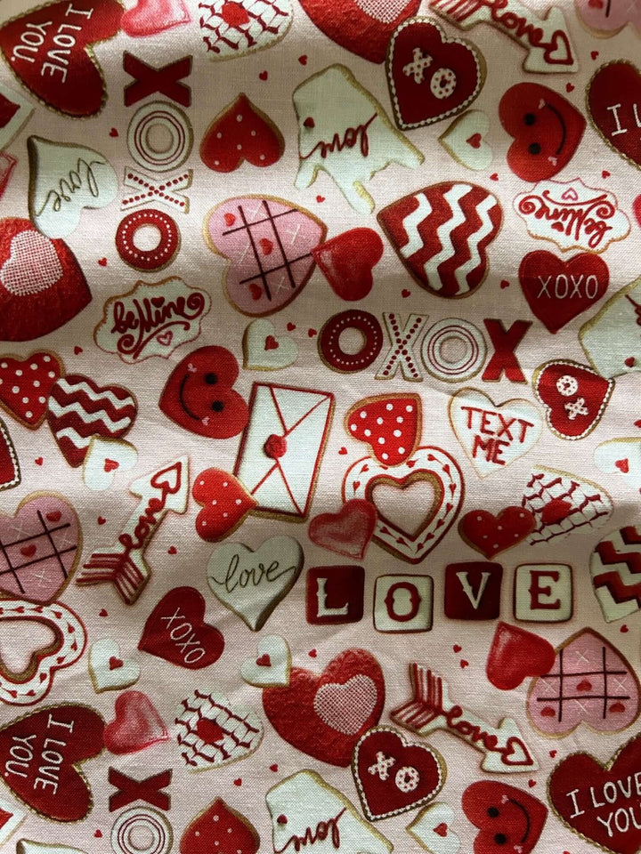 Vintage Tops This top is for the vintage lover at heart! Shown in our XOXO print, this 100% cotton top features bust darts for a flattering silhouette, a side zippered closure for ease of wear, and an oversized bow at the neckline for that perfect 1950's inspired look.