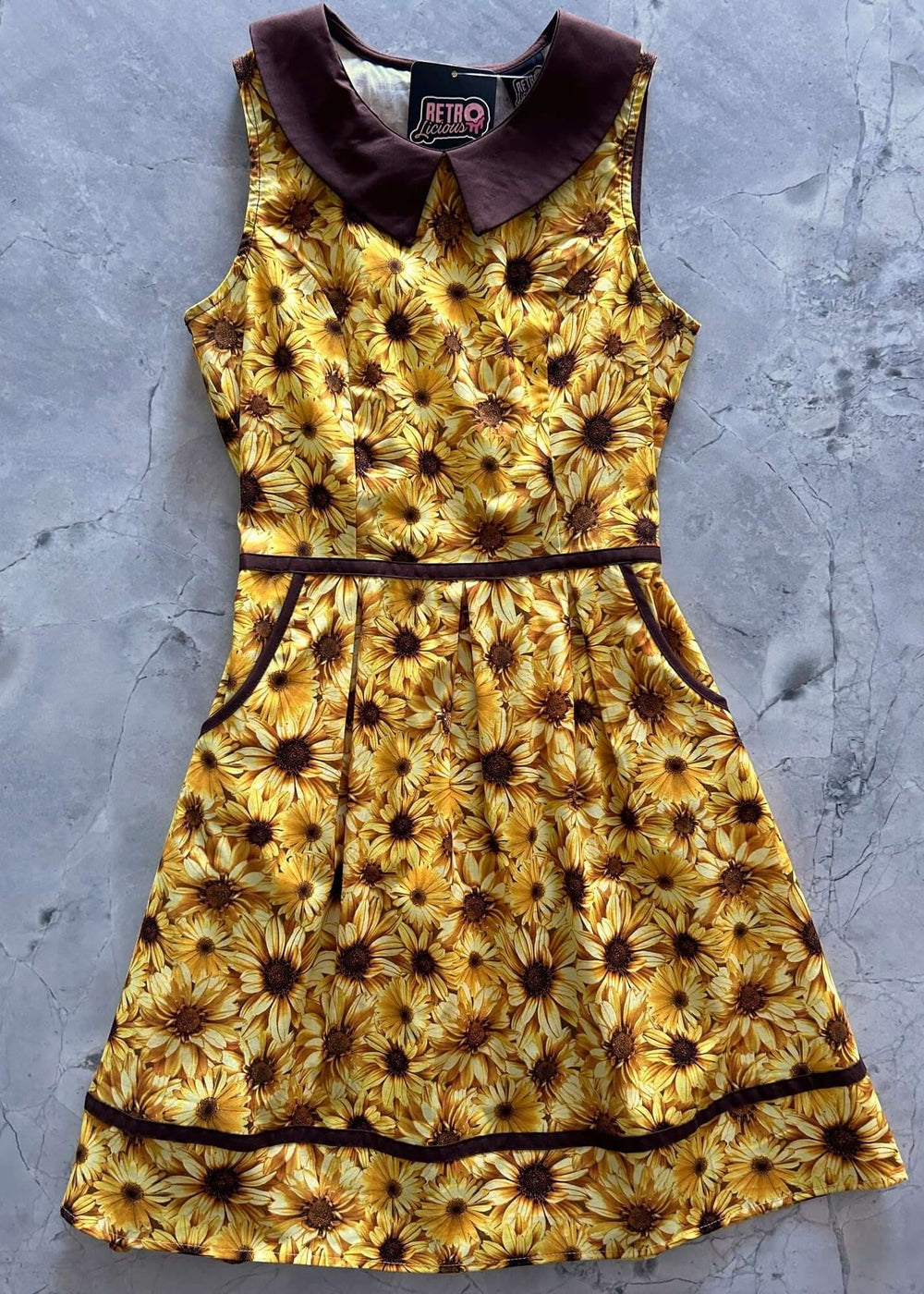 Made in USA Women's Quirky Fun Dress and totally functional, this retro dress is bound to be your new favorite! Shown in our Honey print, this 60s style cotton dress features a contrast Peter Pan collar, contrast piping throughout, a-line skirt with side pockets, and a back zippered closure. 
