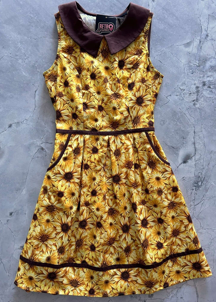 Made in USA Women's Quirky Fun Dress and totally functional, this retro dress is bound to be your new favorite! Shown in our Honey print, this 60s style cotton dress features a contrast Peter Pan collar, contrast piping throughout, a-line skirt with side pockets, and a back zippered closure. 