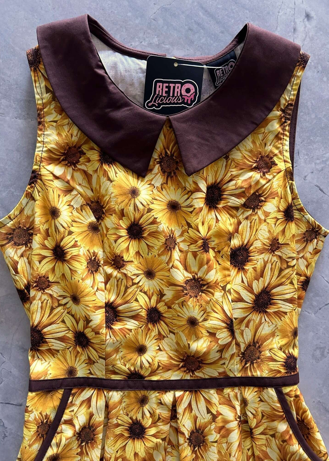 Made in USA Women's Quirky Fun Dress and totally functional, this retro dress is bound to be your new favorite! Shown in our Honey print, this 60s style cotton dress features a contrast Peter Pan collar, contrast piping throughout, a-line skirt with side pockets, and a back zippered closure. 