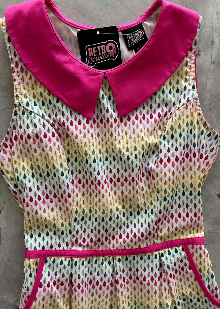 Mod Style Made in USA Dress, Fun and totally functional, this retro dress is bound to be your new favorite! Shown in our Rainbow Drop print, this 60s style cotton dress features a contrast Peter Pan collar, contrast piping throughout, a-line skirt with side pockets, and a back zippered closure.