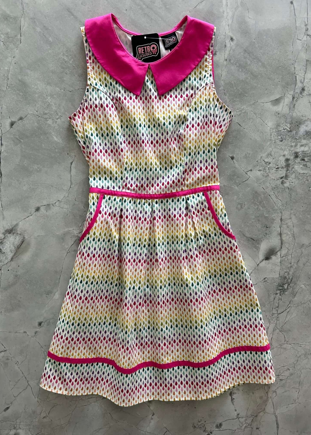 Mod Style Made in USA Dress, Fun and totally functional, this retro dress is bound to be your new favorite! Shown in our Rainbow Drop print, this 60s style cotton dress features a contrast Peter Pan collar, contrast piping throughout, a-line skirt with side pockets, and a back zippered closure.