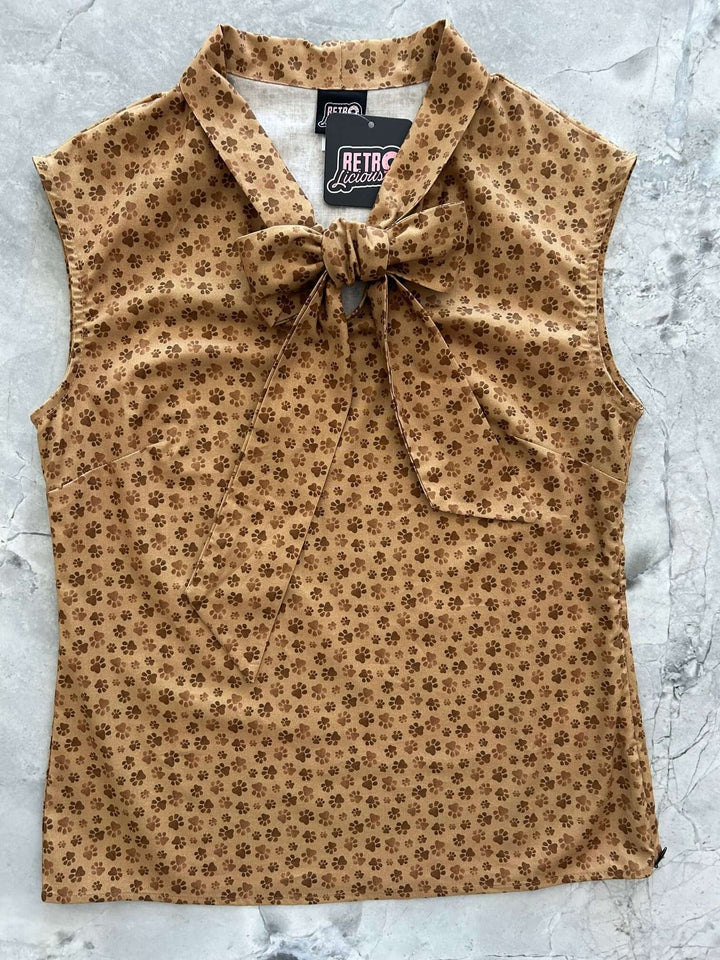 Vintage Style Tops This top is for the vintage lover at heart! Now available in our Paw print. This 100% cotton top features bust darts for a flattering silhouette, a side zippered closure for ease of wear, and an oversized bow at the neckline for that perfect 1950's inspired look.