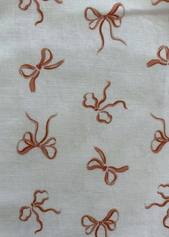 Vintage Style Tops This top is for the vintage lover at heart! Now available in our Pink Bows print. This 100% cotton top features bust darts for a flattering silhouette, a side zippered closure for ease of wear, and an oversized bow at the neckline for that perfect 1950's inspired look.