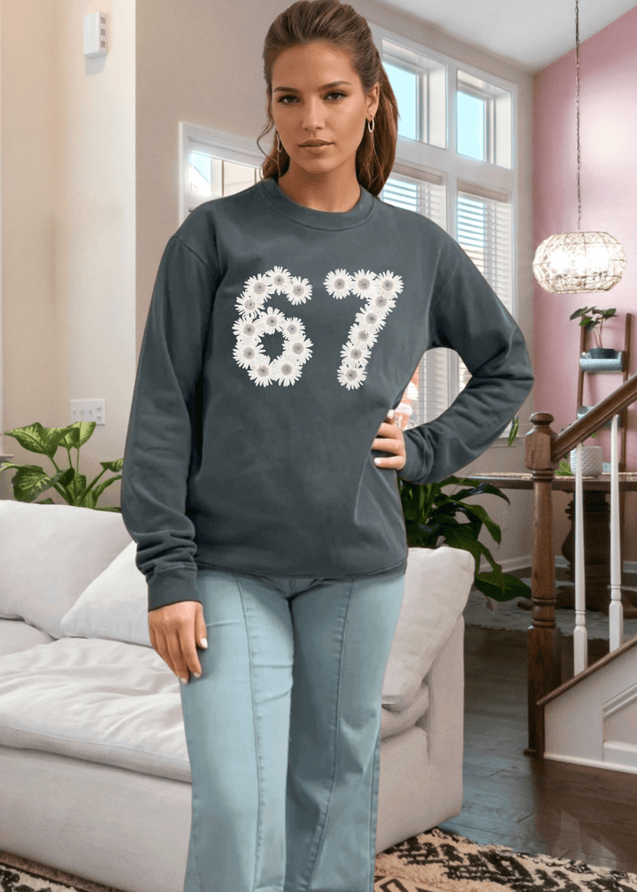 Elevate your everyday wardrobe with this heavyweight pigment-dyed cotton sweatshirt, crafted right here in the USA. Featuring a striking 67 floral graphic on a rich evergreen base, it's the perfect blend of artistic style and comfort. 