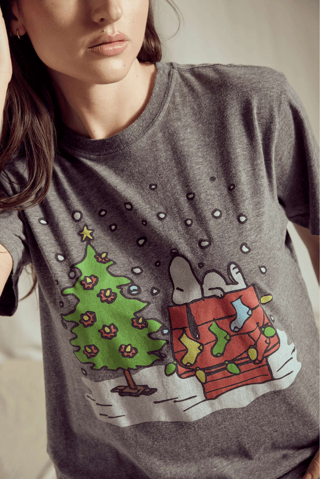 Celebrate the joy of the holiday season with the ultimate dose of nostalgia! Our Snoopy's Christmas Tree Tee captures the simple, heartwarming spirit of the beloved Peanuts gang. 