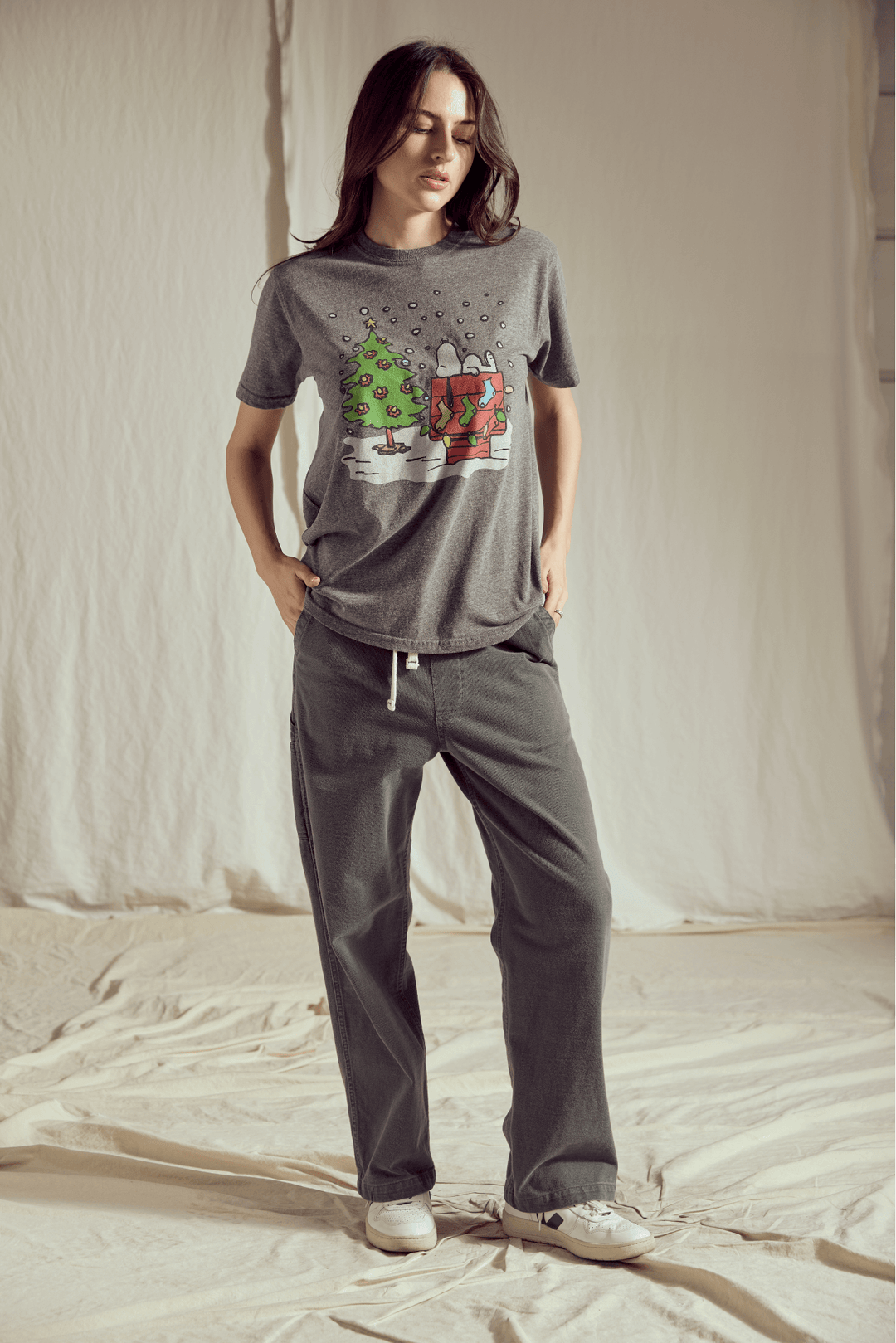 Celebrate the joy of the holiday season with the ultimate dose of nostalgia! Our Snoopy's Christmas Tree Tee captures the simple, heartwarming spirit of the beloved Peanuts gang. 