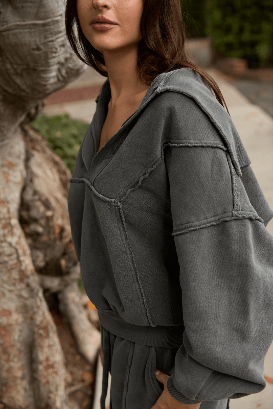 Ryanne Sweatshirt by People of Leisure — 100% organic cotton, deep V-neck, raw edges in Camel & Vintage Black. Made in LA. Sizes XS–XL