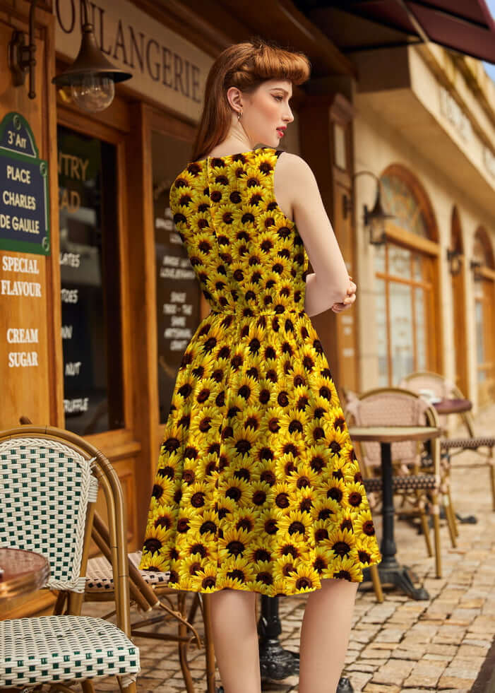 Made in USA by Retrolicious, this 100% cotton sunflower vintage dress features a high neckline, full skirt, pockets, and back zip. Sizes XS–4X.