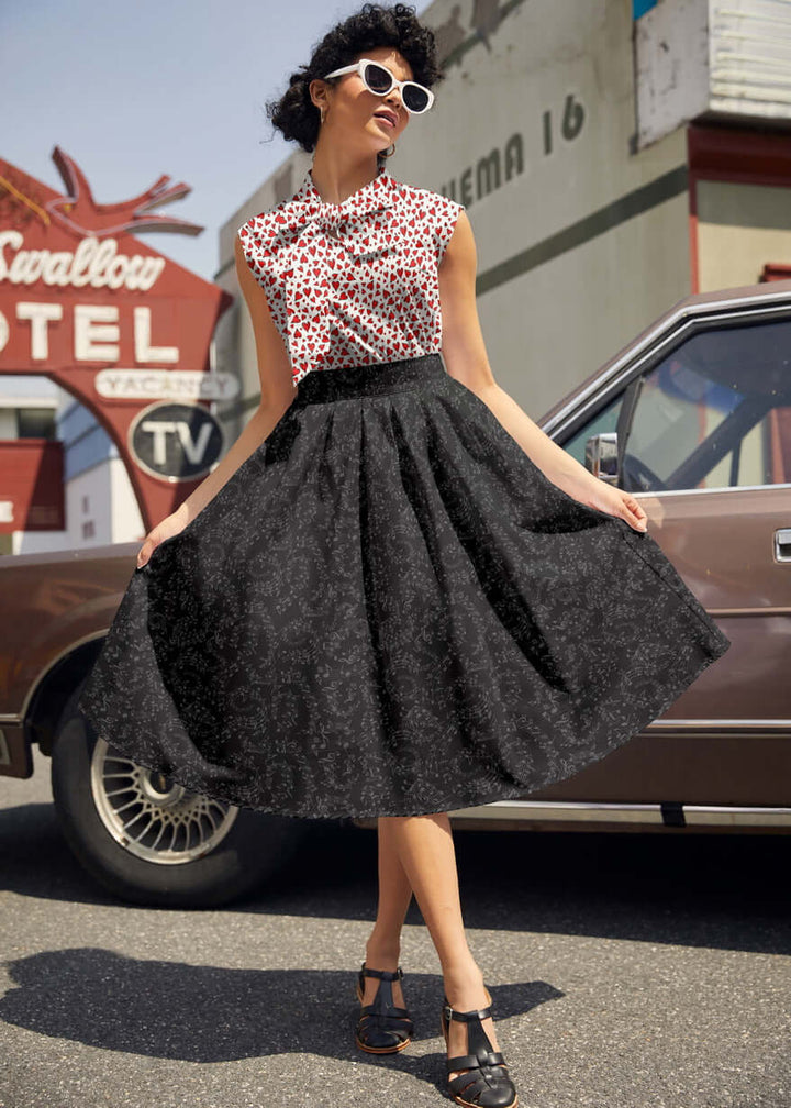 Made in USA. Shop the Music Notes Doris cotton skirt by Retrolicious, with a longer pleated silhouette, pockets and elasticized back waist. 