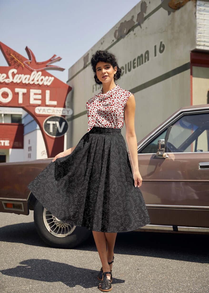 Made in USA. Shop the Music Notes Doris cotton skirt by Retrolicious, with a longer pleated silhouette, pockets and elasticized back waist. 