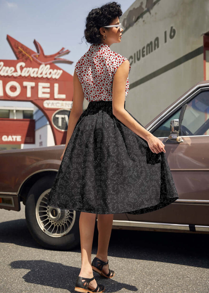 Made in USA. Shop the Music Notes Doris cotton skirt by Retrolicious, with a longer pleated silhouette, pockets and elasticized back waist. 