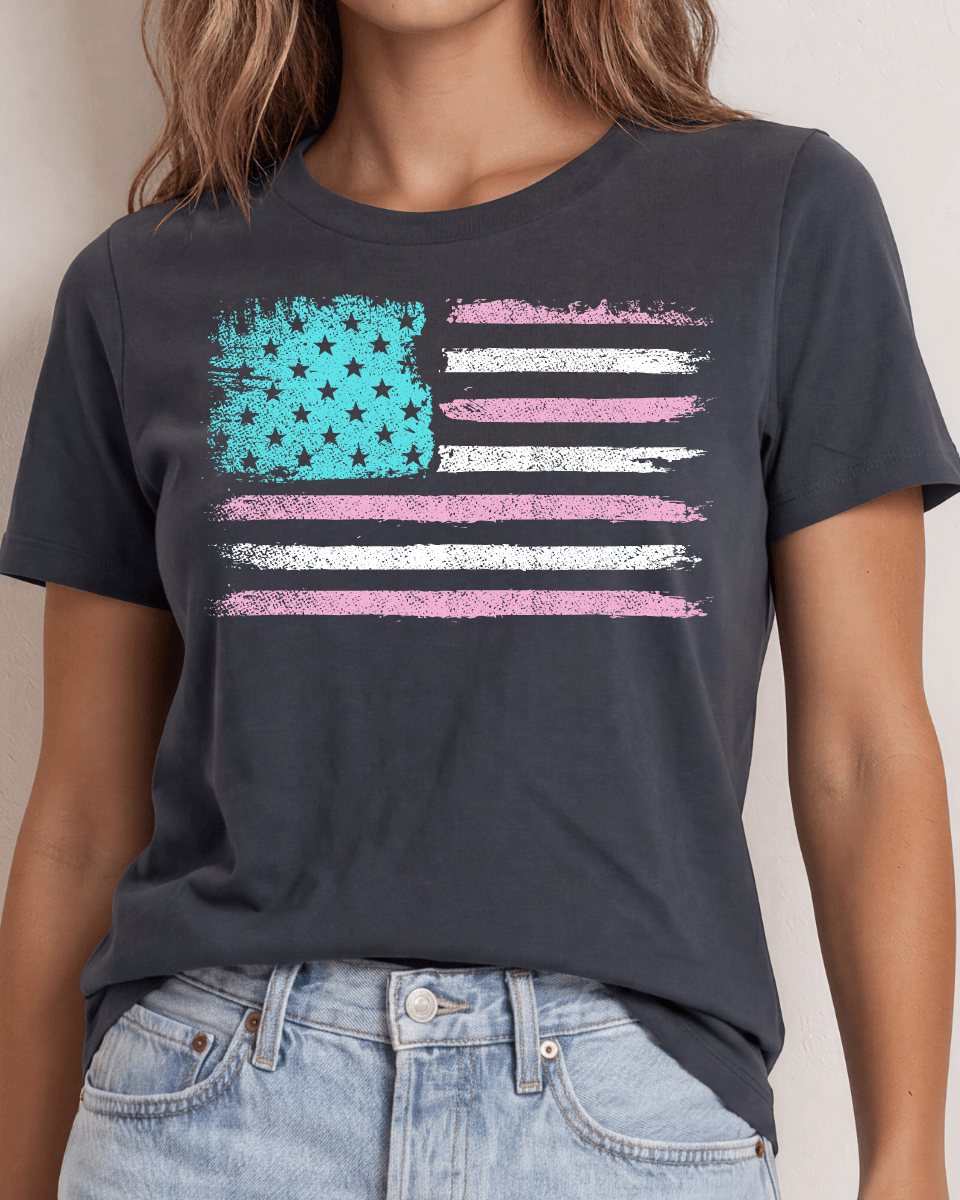 Distressed American flag graphic tee in aqua, pink &amp; white on graphite. 100% cotton, USA-milled fabric, made in USA. A feminine patriotic twist.