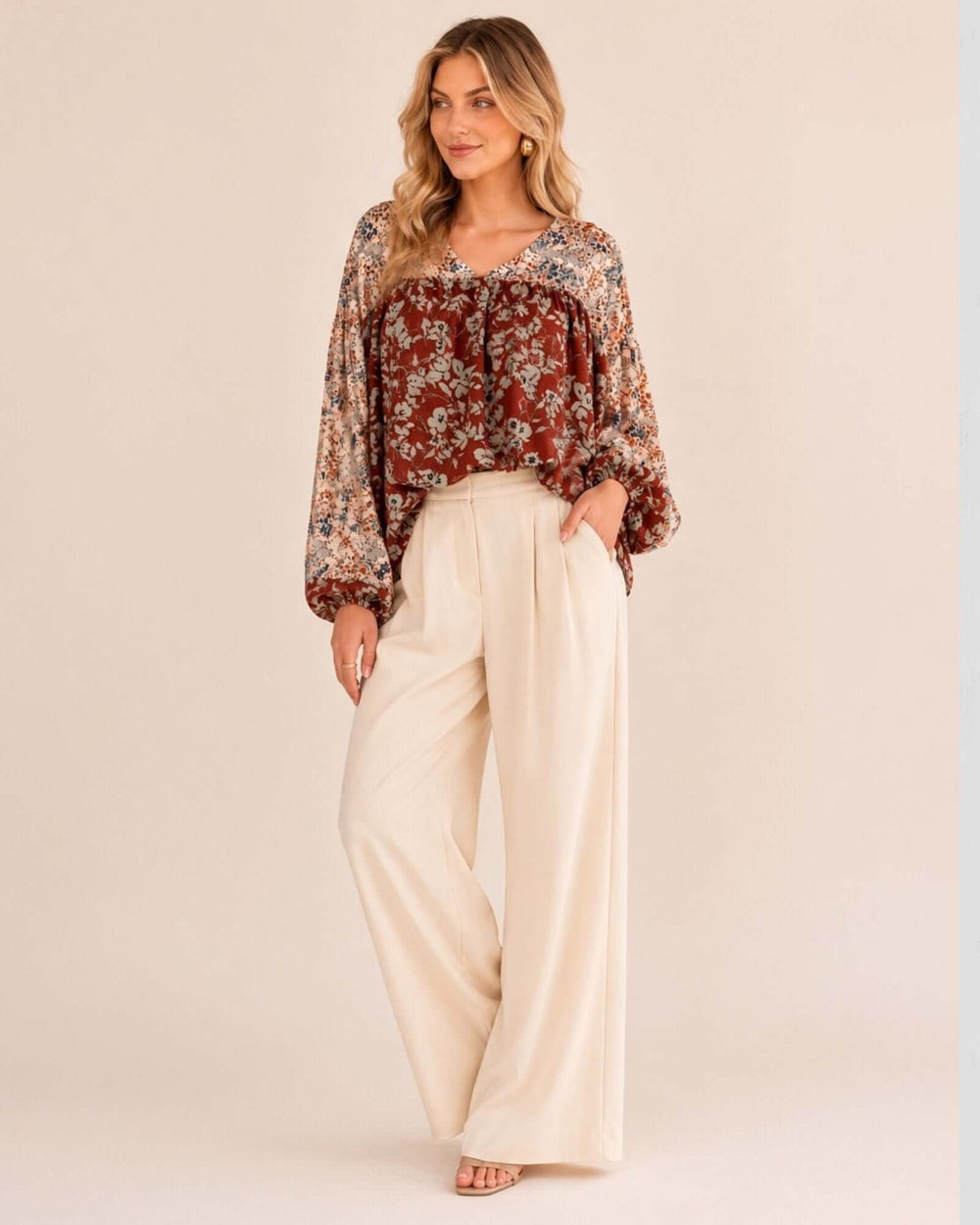 Made in USA women's rust and cream mixed floral V-neck babydoll top with balloon sleeves and elastic cuffs, full length view with cream wide-leg pants