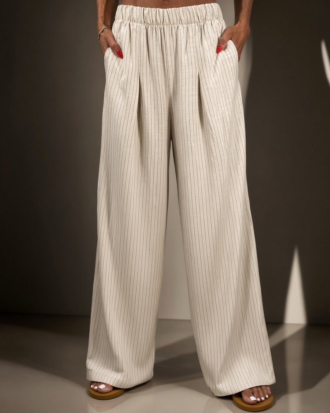 Avery high-rise wide leg pinstripe pant in ivory. Elastic waist, pleated front, full length. 85% rayon, 15% linen. Made in USA. Sizes S–L.