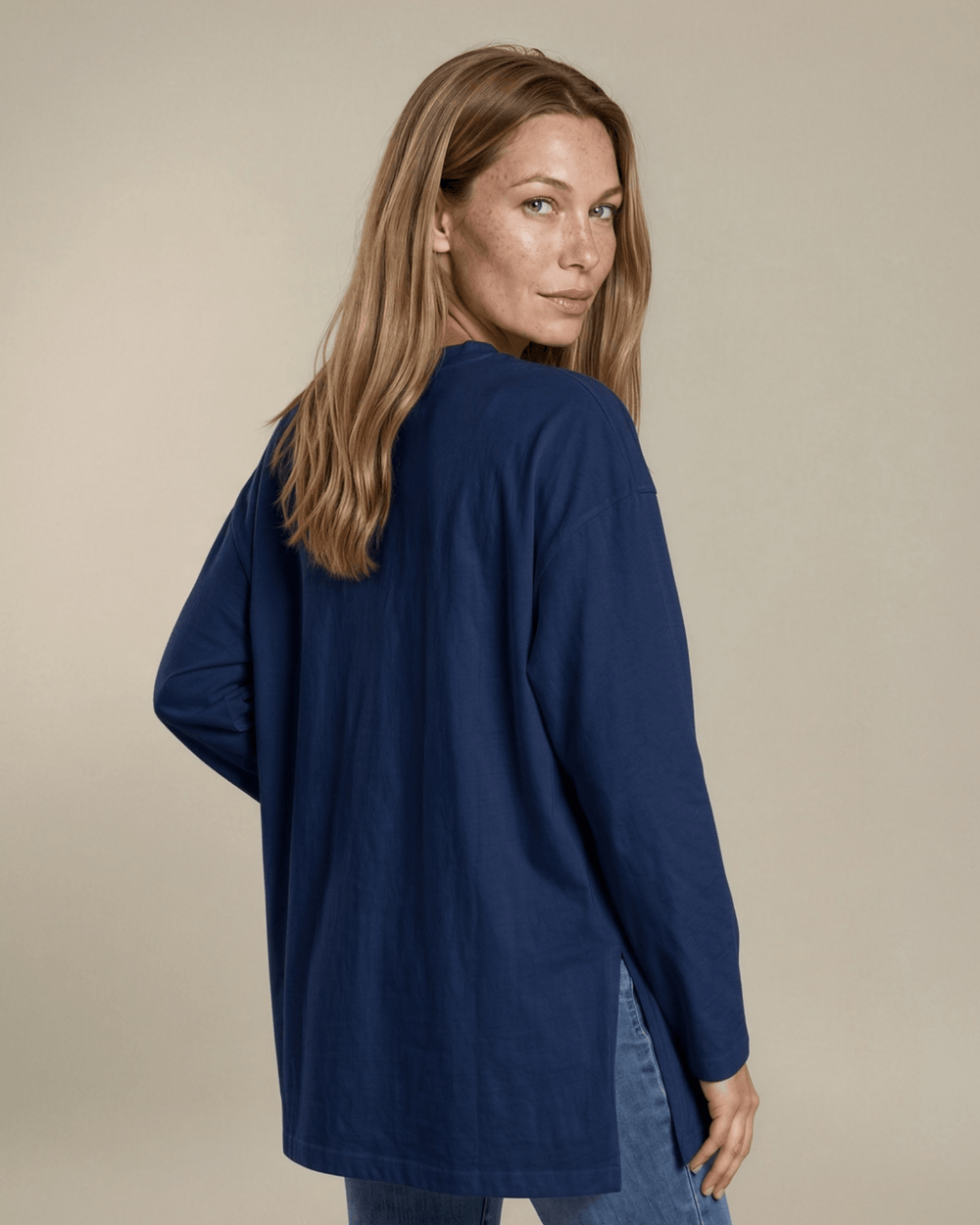 Made in USA. Women's navy blue long sleeve cotton top with a crew neck, relaxed fit and side slits. Soft 95% cotton with stretch for easy everyday layering.